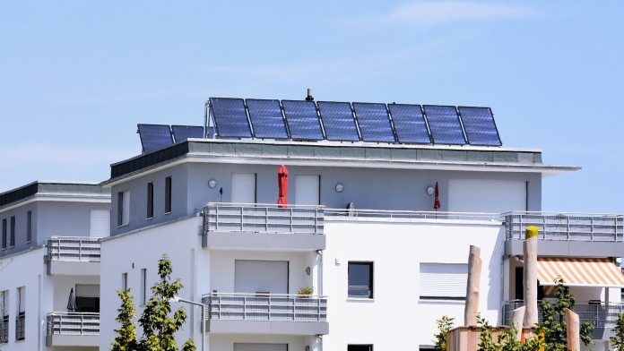 Modern apartment building equipped with multiple solar panels