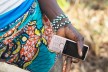 A hand of a woman from Guinea holding a mobile phone