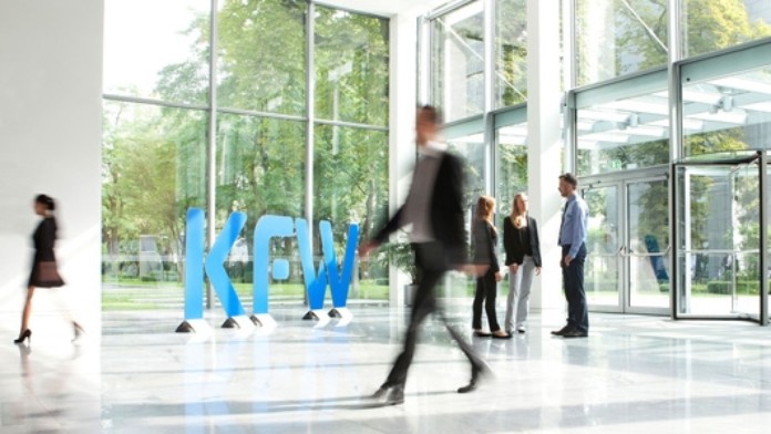 Employees walk throug the entrance of KfW Group, Frankfurt