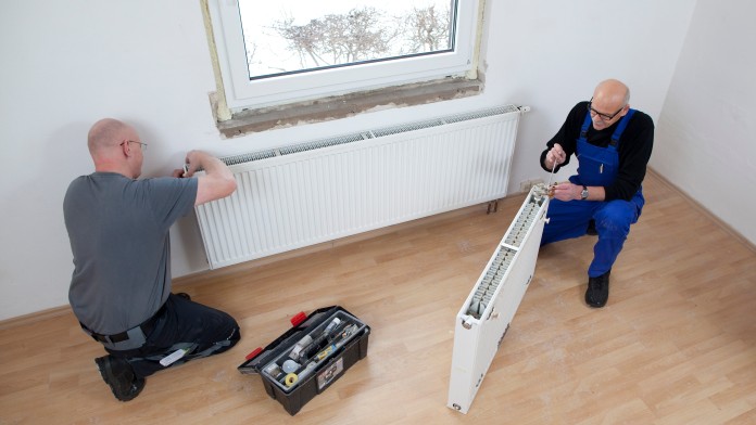 Two technicians substitute an heater