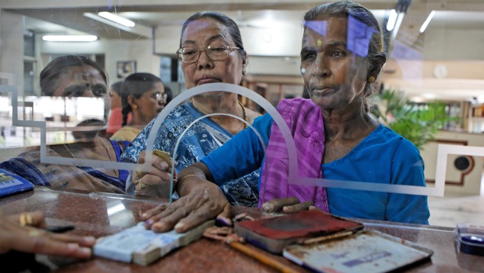 Women with cash at a bank counter