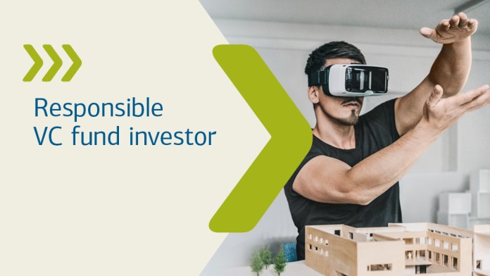 Woman with blazer stands with folded arms and smiles into the camera