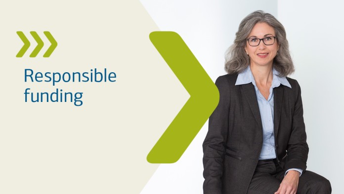 A man in a blue suit walks through a corridor