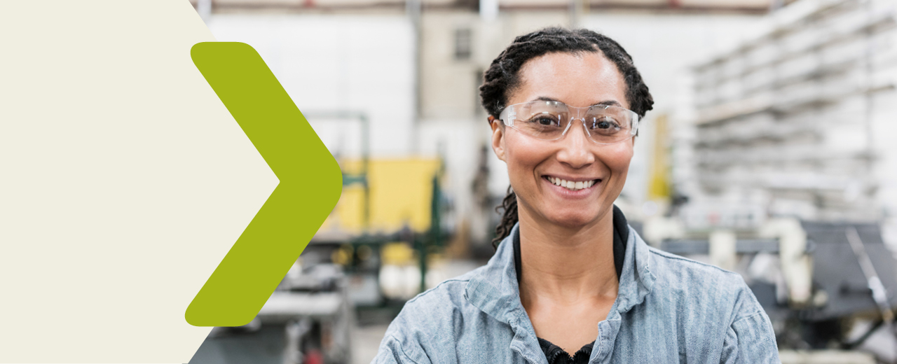 Young woman with safety goggles in a production shop