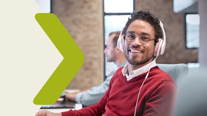 Portrait of a young man with headphones at the office