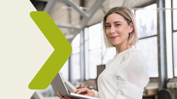 Portrait of a woman with a laptop in a production facility