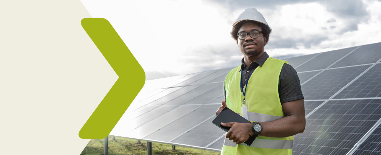 A worker stands in front of a photovoltaic plant