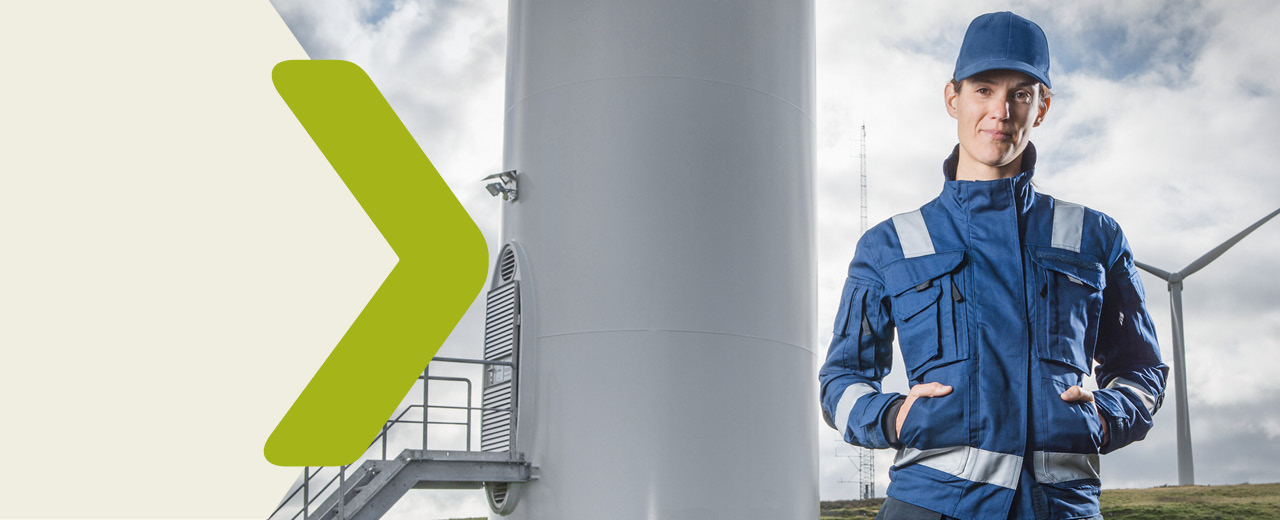 Portrait of a woman in front of a wind farm