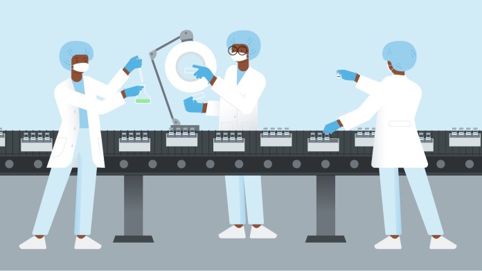 People in white coats stand at a pharmaceutical production line
