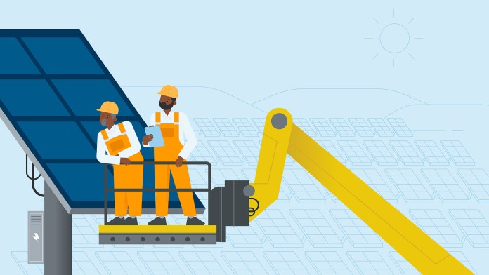 Two labourers work on a platform at a solar field