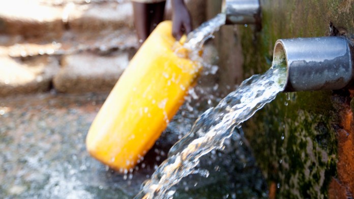 Filling water into a yellow canister