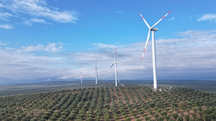 Four wind turbines on a gentle hill
