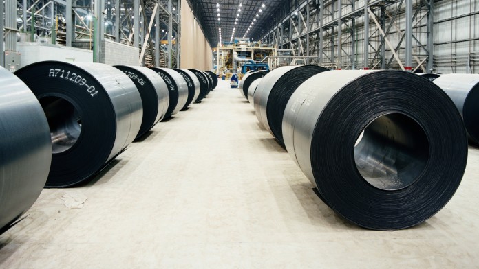 Rolls with finished steel plates in the warehouse of a steel factory