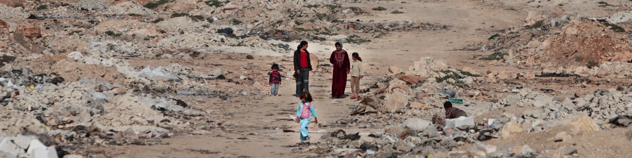 children and women coming from a town
