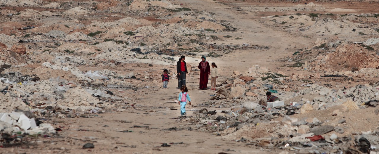 children and women coming from a town