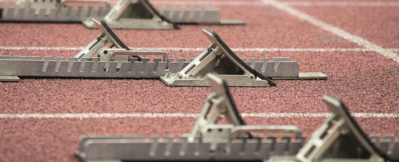 Several empty starting blocks on running tracks