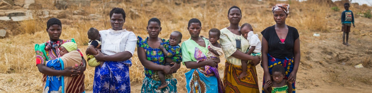 children and women coming from a town