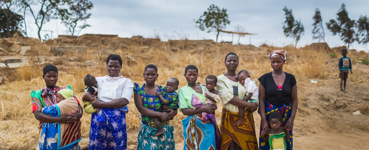 children and women coming from a town