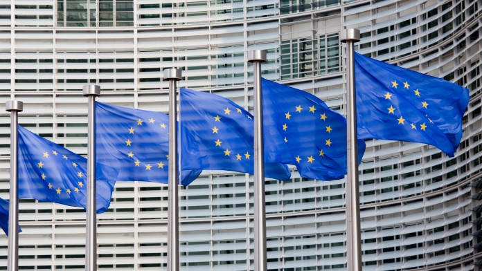 EU flags in front of the building of the European Commission in Brussels