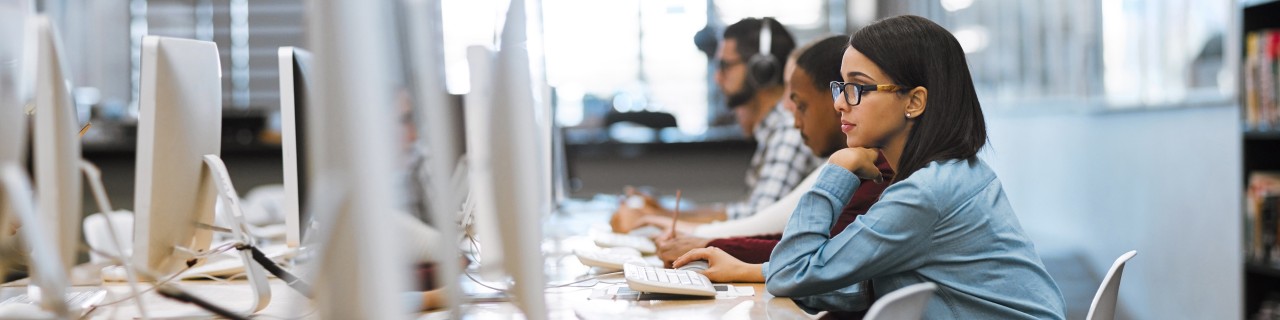 Aufnahme einer Gruppe von Universitätsstudenten bei der Arbeit an Computern in der Bibliothek