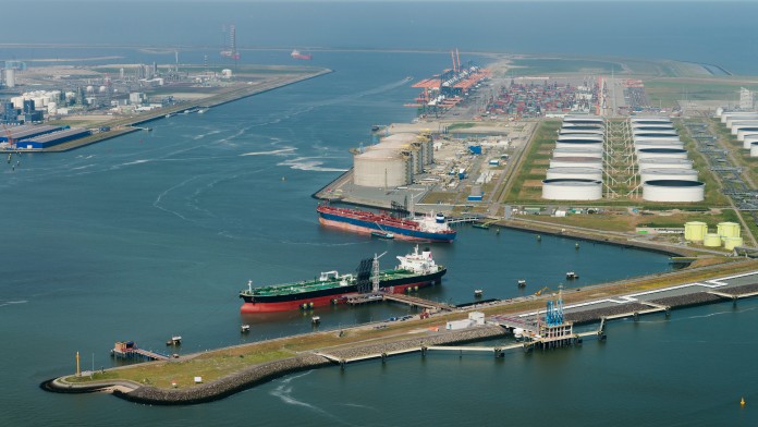 Container in a port, behind it a cargo ship