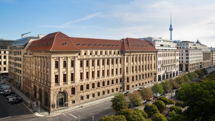 Slightly elevated exterior view of the KfW branch in Berlin with television tower in the background