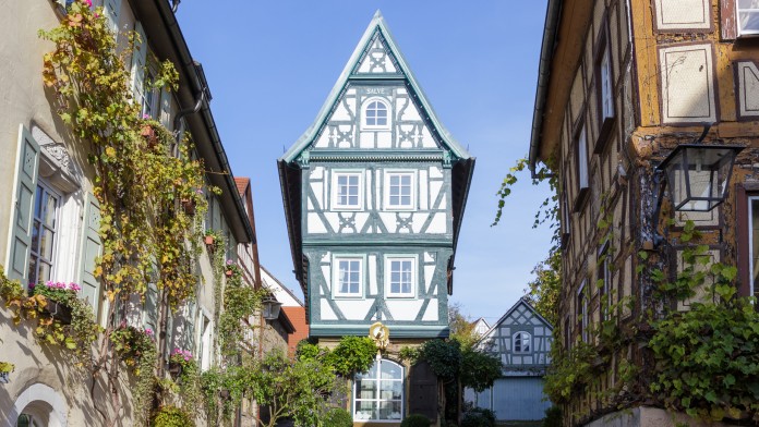 View of a renovated half-timbered house at the end of a street