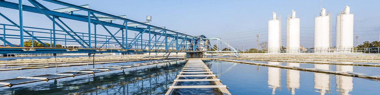 Secondary clarifier of a wastewater treatment plant, 4 towers in the background
