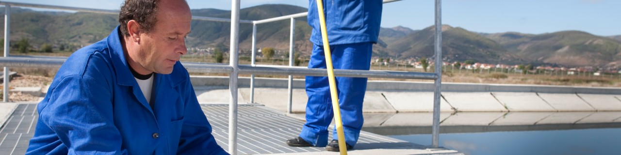 Employee checks the water quality in a sewage treatment plant