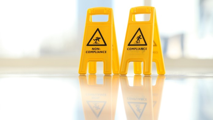 A symbolic image, smooth tiled floor with warning signs about the risk of slipping