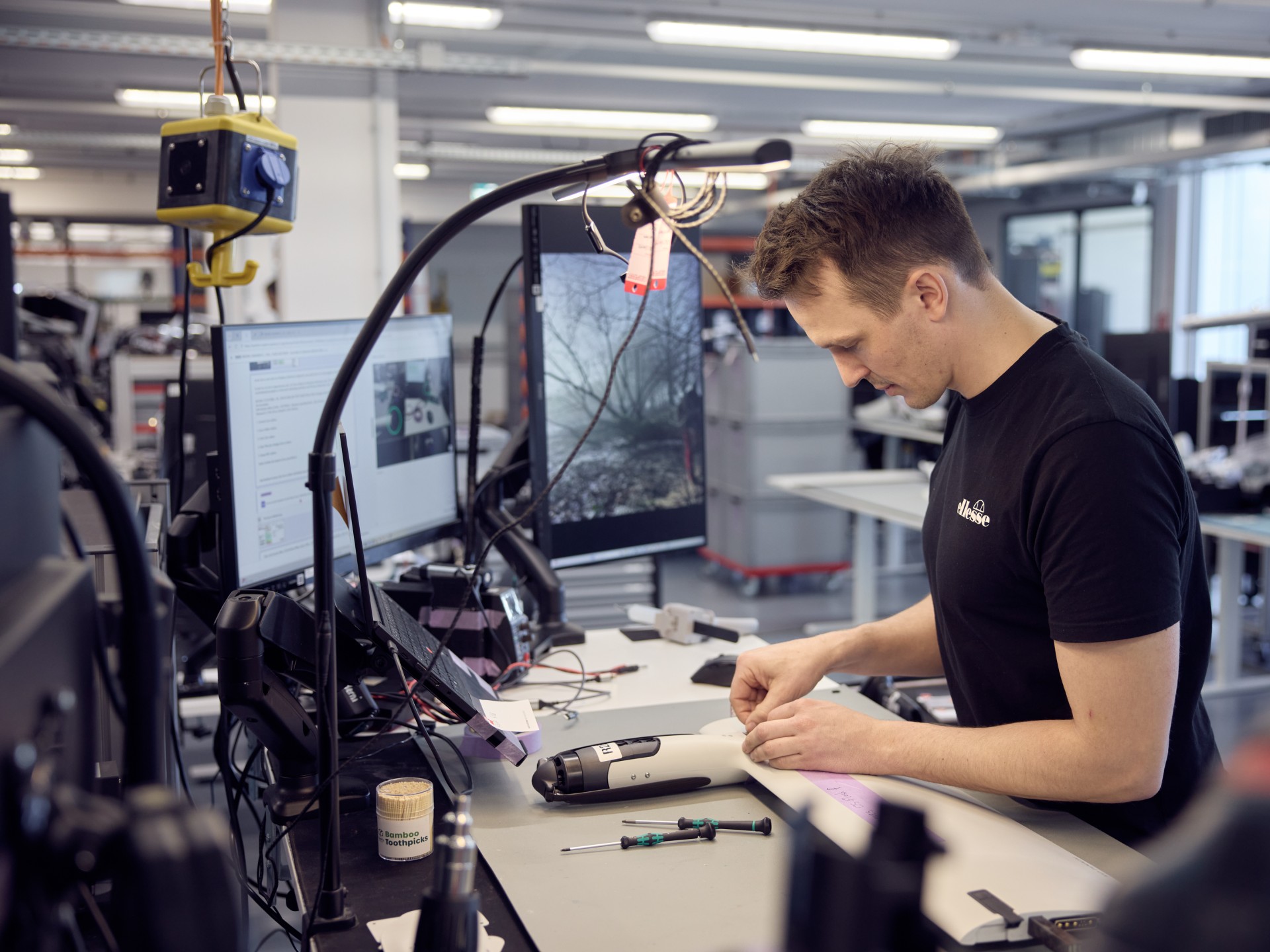 An employee at his workstation assembling a drone