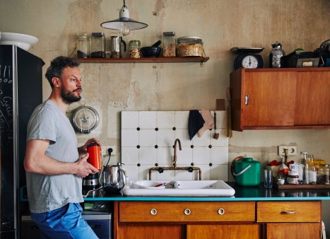 Lutz-Rainer Müller in his kitchen with old furniture