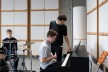 Pupils Maxim Parkhomenko (right) and Victor Grueter (left) receive music lessons from David Saposhnikov (centre) at the Tumo Center in Berlin.