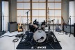 A drum kit and other music equipment in a recording studio