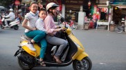 Famliy riding a moped in Vietnam