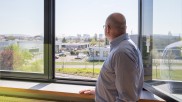 Nicholas Benedict looking out of the window of his office.