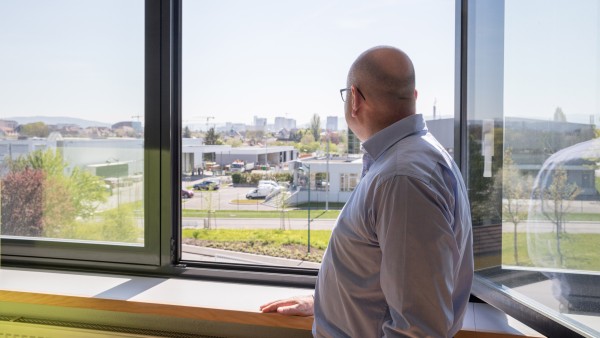 Nicholas Benedict looking out of the window of his office.