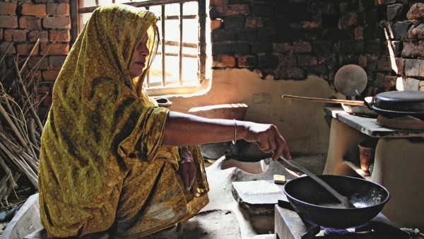 Woman cooking on biogas stove