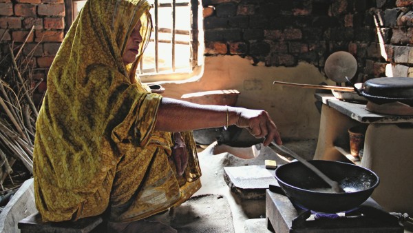 Woman cooking on biogas stove