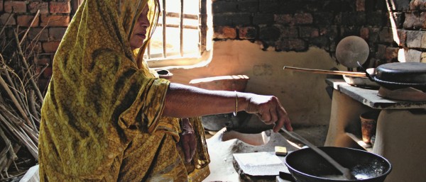 Woman cooking on biogas stove