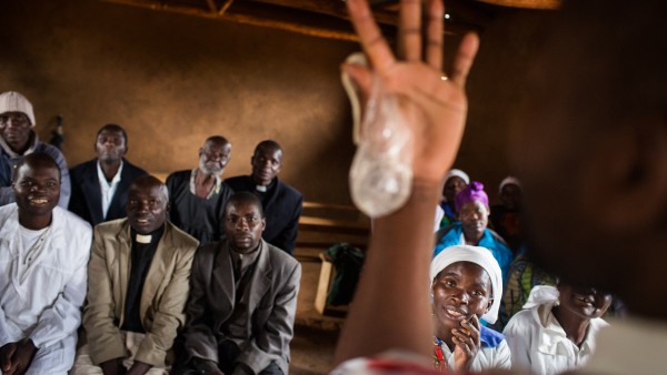 A condom is shown during a hiv prevention seminar for priests and other listeners