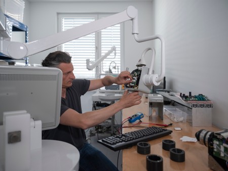 A technician working on the Magnosco laser