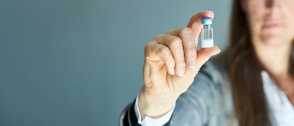 A woman holds an ampoule of Hepcludex, powder for injection preparation in her hand