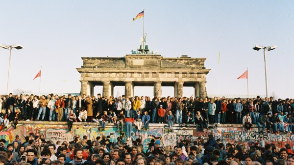 Crowd on and in front of Berlin Wall at Brandenburg Gate