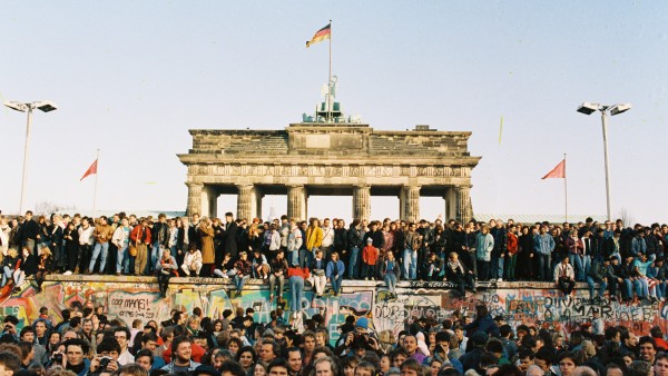 Crowd on and in front of Berlin Wall at Brandenburg Gate