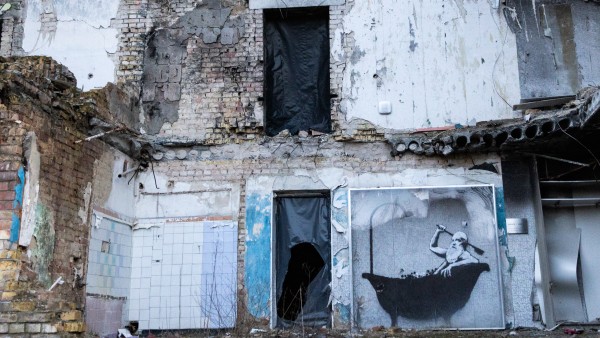 A residential building in Kyiv destroyed by a Russian missile attack with street art graffiti by Banksy