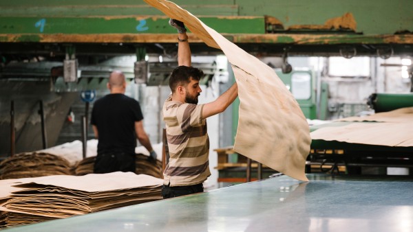 A worker at a funier plant stacks and checks a finished funier