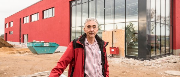 Peter Kuepper in front of his red house