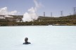 A woman takes a swim in a cooling basin at Olkaria geothermal power plant