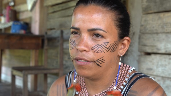 Portrait of Aldeise da Silva Mendoca with indigenous face paint during an interview